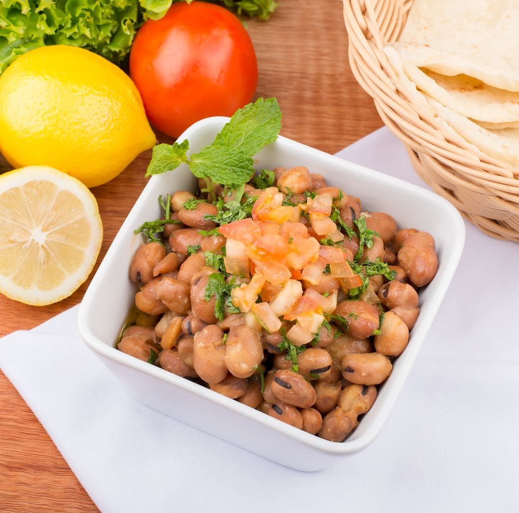 Tasty Mediterranean fava bean salad with fresh lemons, tomatoes, and herbs, perfect for a healthy meal.
